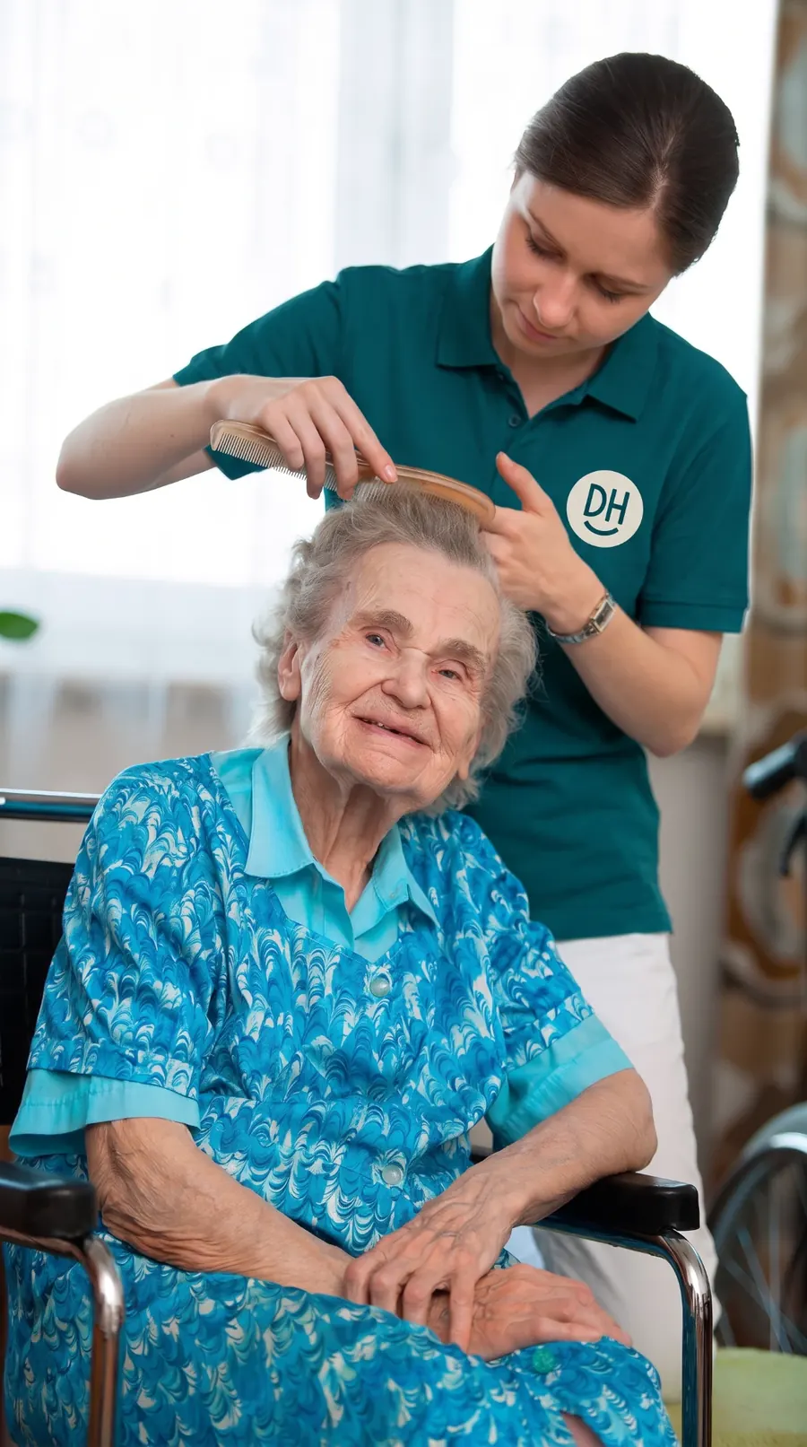 A carer gently combing an older woman's hair